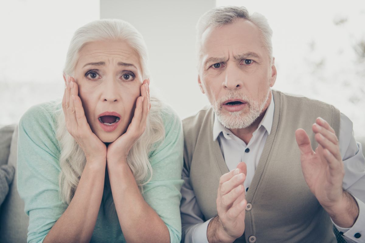 A mature couple looking shocked