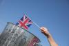 British flag being dropped into a dustbin