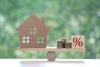 estate-tax-model-house-with-percentage-symbol-icon-on-green-background-business